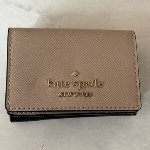 Kate Spade micro tri-fold wallet in beige and black.